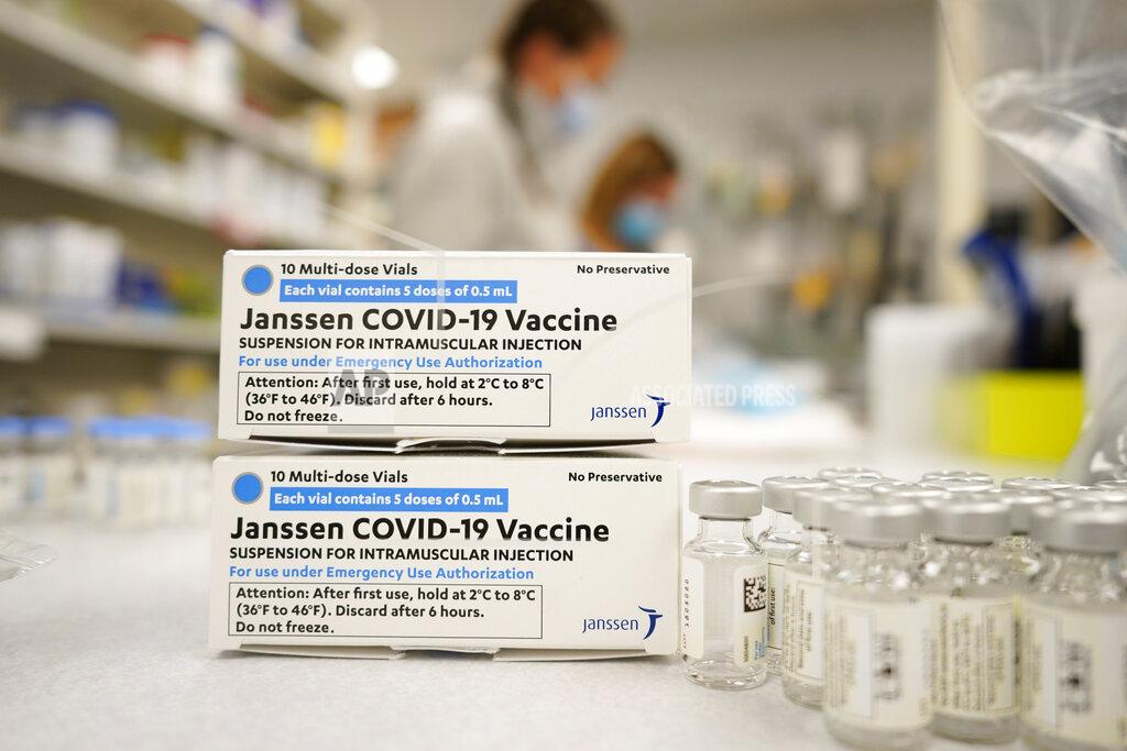 FILE - In this March 6, 2021, file photo, boxes stand next vials of Johnson & Johnson COVID-19 vaccine in the pharmacy of National Jewish Hospital for distribution in Denver. U.S. health officials are weighing next steps as they investigate unusual blood clots in a small number of people given the vaccine -- a one-dose shot that many countries hoped would help speed protection against the pandemic. (AP Photo/David Zalubowski, File)