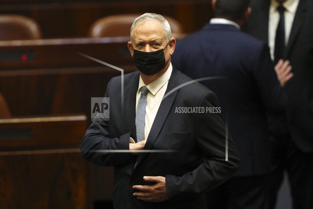 Ariel Schalit Israeli politician Benny Gantz stands during a Knesset session in Jerusalem Sunday, June 13, 2021. Bennett is expected later Sunday to be sworn in as the country's new prime minister, ending Prime Minister Benjamin Netanyahu's 12-year rule. (AP Photo/Ariel Schali22