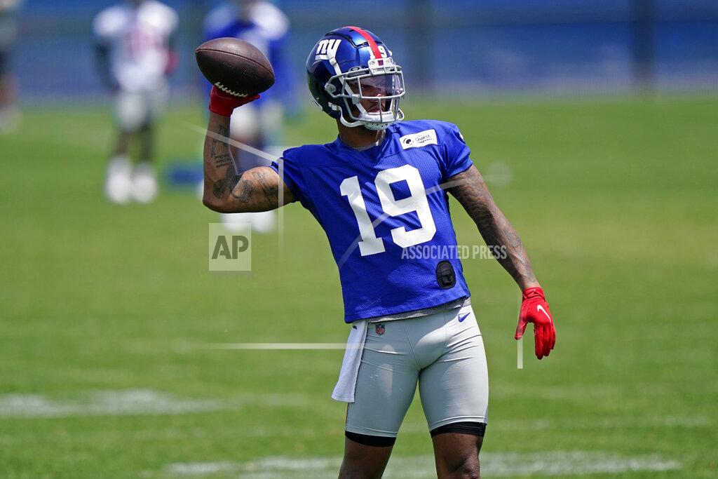 New York Giants wide receiver Kenny Golladay (19) passes the ball back to an assistant while running through light drills during an NFL football practice with the team, Thursday, June 10, 2021, in East Rutherford, N.J. (AP Photo/Kathy Willens)