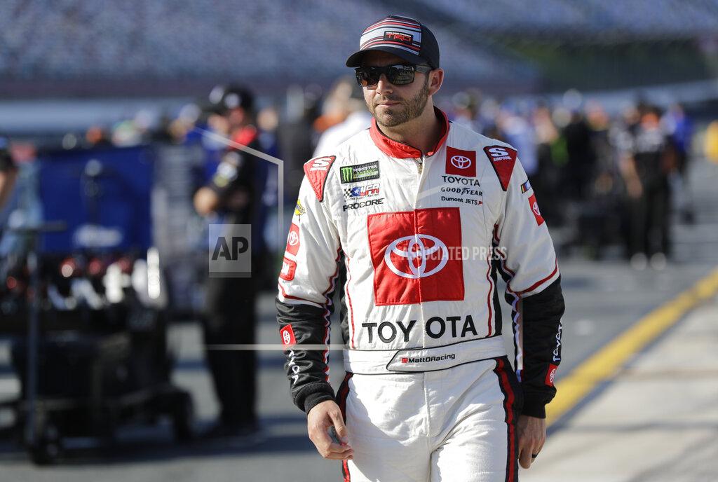 Chuck Burton Matt DiBenedetto walks down pit road before qualifying for Saturday's NASCAR All-Star Cup series auto race at Charlotte Motor Speedway in Concord, N.C., Friday, May 17, 2019. (AP Photo/Chuck Burton)