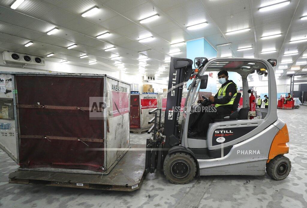 Kamran Jebreili A Pfizer-BioNTech COVID-19 coronavirus vaccine shipment is offloaded into a refrigerated storage space at Dubai International Airport cargo terminal, in Dubai, United Arab Emirates, early Sunday, Feb. 21, 2021. As the coronavirus pandemic continues to clobber the aviation industry, Emirates Airlines, the Middle East’s biggest airline is seeking to play a vital role in the global vaccine delivery effort. (AP Photo/Kamran Jebreili)