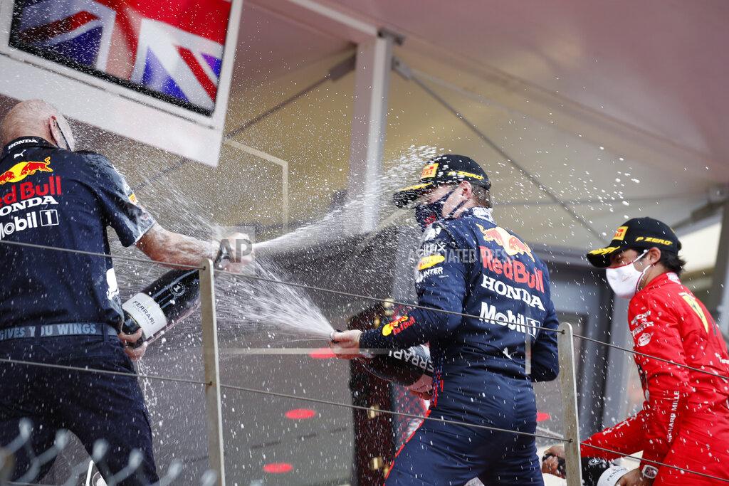 Sebastien Nogier First place Red Bull driver Max Verstappen of the Netherlands, center, and second place Ferrari driver Carlos Sainz of Spain, right, celebrate on the podium during the Monaco Grand Prix at the Monaco racetrack, in Monaco, Sunday, May 23, 2021. (Sebastien Nogier, Pool via AP)