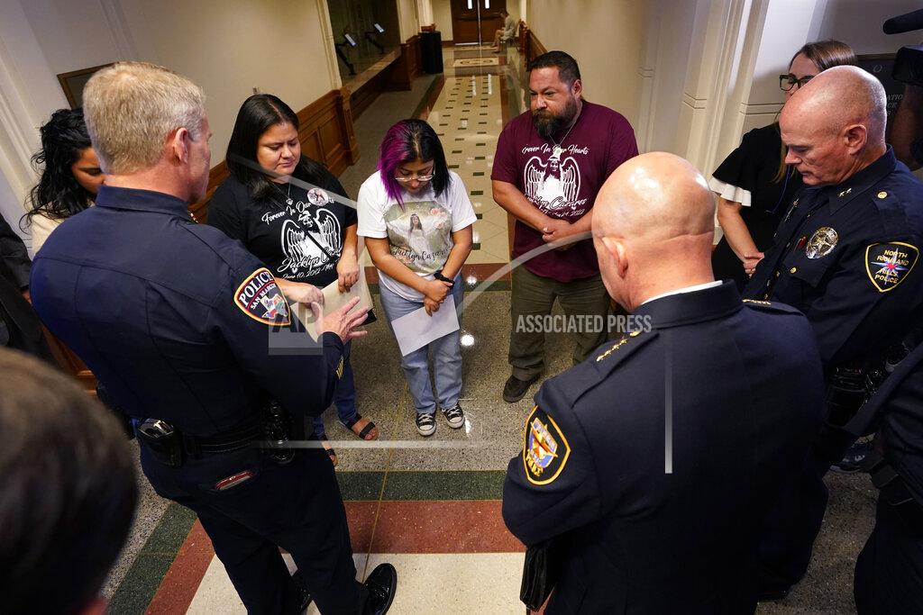 Eric Gay Jazmin Cazares, center, whose young sister Jacklyn was was one of 19 children killed by a gunman at Robb Elementary School, with her parents, Javier, right, and mother, Gloria, rear, pray with a group of police chiefs after a hearing at the state capitol, Thursday, June 23, 2022, in Austin, Texas. (AP Photo/Eric Gay)