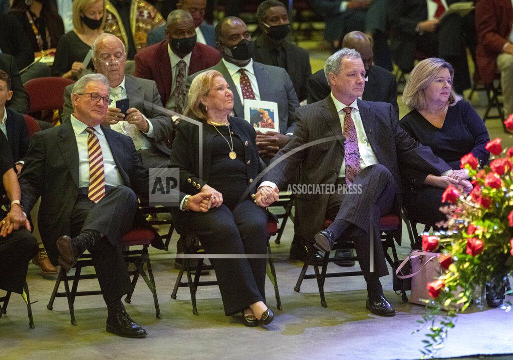Mark Wallheiser Sons Terry Bowden, left, and Tommy Bowden hold hands with their mother, Ann, second from left, during a celebration of life ceremony for their father and her husband, longtime Florida State football coach Bobby Bowden, as he lies in repose at the Tucker Civic Center, Saturday, Aug. 14, 2021, in Tallahassee, Fla. Bowden became the FSU football coach in 1976, transforming the program into one of the best in the country. He coached FSU to national championships in 1993 and 1999. Bowden was 91. (AP Photo/Mark Wallheiser)