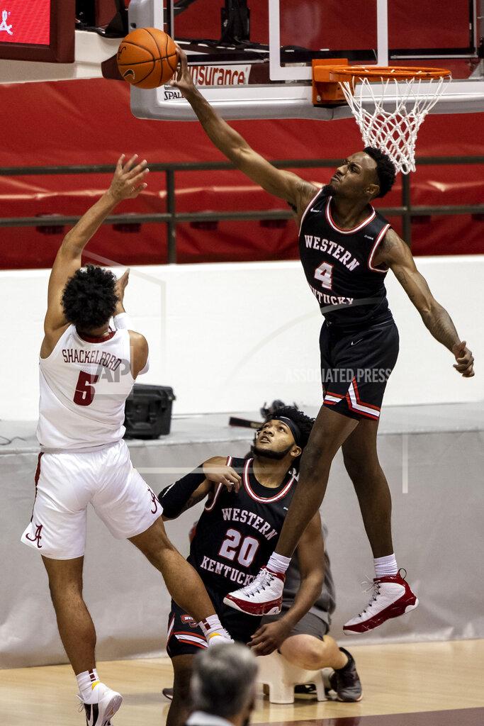 Vasha Hunt Western Kentucky guard Josh Anderson (4) blocks a shot from Alabama guard Jaden Shackelford (5) during the first half of an NCAA college basketball game, Saturday, Dec. 19, 2020, in Tuscaloosa, Ala. (AP Photo/Vasha Hunt)