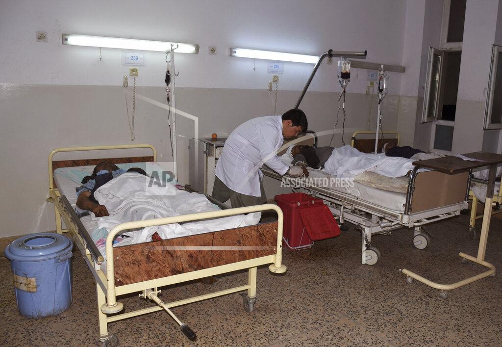 Masih Paeiz Wounded men receive treatment in a hospital, after a bombing in Mazar-e-Sharif, northern Afghanistan, Wednesday, May 25, 2022. A series of explosions shook Afghanistan on Wednesday, the Taliban said, including a blast inside a mosque in the capital of Kabul that killed at least five worshippers and three bombings of minivans in the country's north that killed nine passengers. (AP Photo/Masih Paeiz)