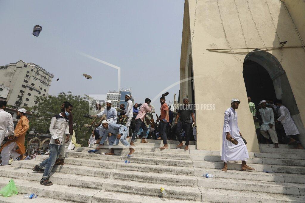 Mahmud Hossain Opu People throw footwear during a protest against the visit of Indian Prime Minister Narendra Modi, after Friday prayers at Baitul Mokarram mosque in Dhaka, Bangladesh, Friday, March 26, 2021. Witnesses said violent clashes broke out after one faction of protesters began waving their shoes as a sign of disrespect to Indian Prime Minister Narendra Modi, and another group tried to stop them. Local media said the protesters who tried to stop the shoe-waving are aligned with the ruling Awami League party. The party criticized the other protest faction for attempting to create chaos in the country during Modi’s visit. (AP Photo/Mahmud Hossain Opu)