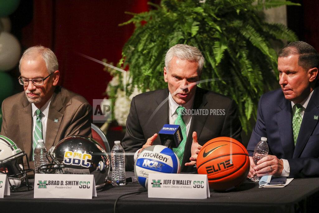 Ryan Fischer Marshall University president-elect Brad D. Smith, center, is flanked by Marshall president Dr. Jerome A. Gilbert, left, and interim director of athletics Jeff O'Malley during a press conference about joining the Sun Belt Conference, Monday, Nov. 1, 2021, in Huntington, W.Va. (Ryan Fischer/The Herald-Dispatch via AP)