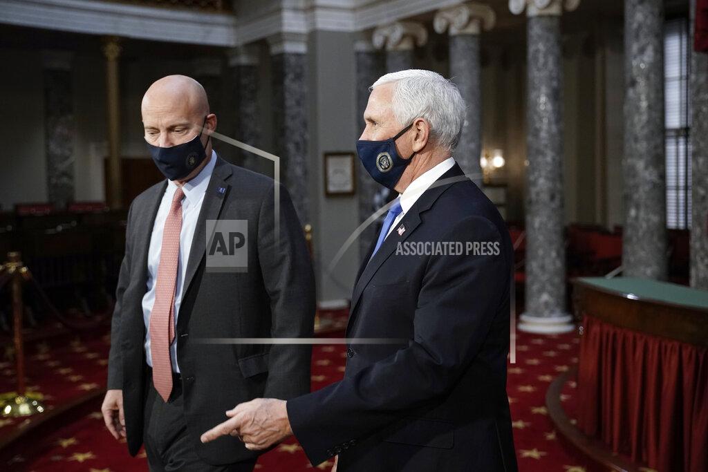 J. Scott Applewhite Vice President Mike Pence, joined at left by chief of staff Marc Short, finishes a swearing-in ceremony for senators in the Old Senate Chamber at the Capitol in Washington, Sunday, Jan. 3, 2021. (AP Photo/J. Scott Applewhite, Pool)