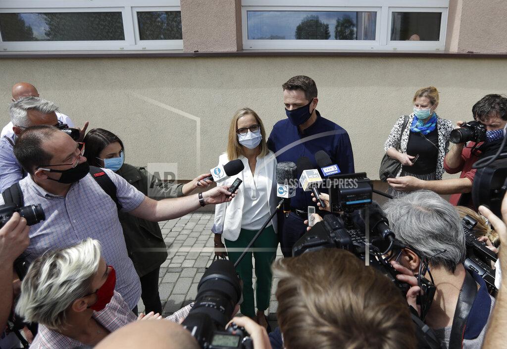 Petr David Josek Presidential candidate Rafal Trzaskowski accompanied by his wife Malgorzata addresses media after casting his vote during the presidential election runoff in Rybnik, Poland, Sunday, July 12, 2020. Voting started Sunday in Poland's razor-blade-close presidential election runoff between the conservative incumbent Andrzej Duda and liberal, pro-European Union Warsaw Mayor Rafal Trzaskowski. (AP Photo/Petr David Josek)