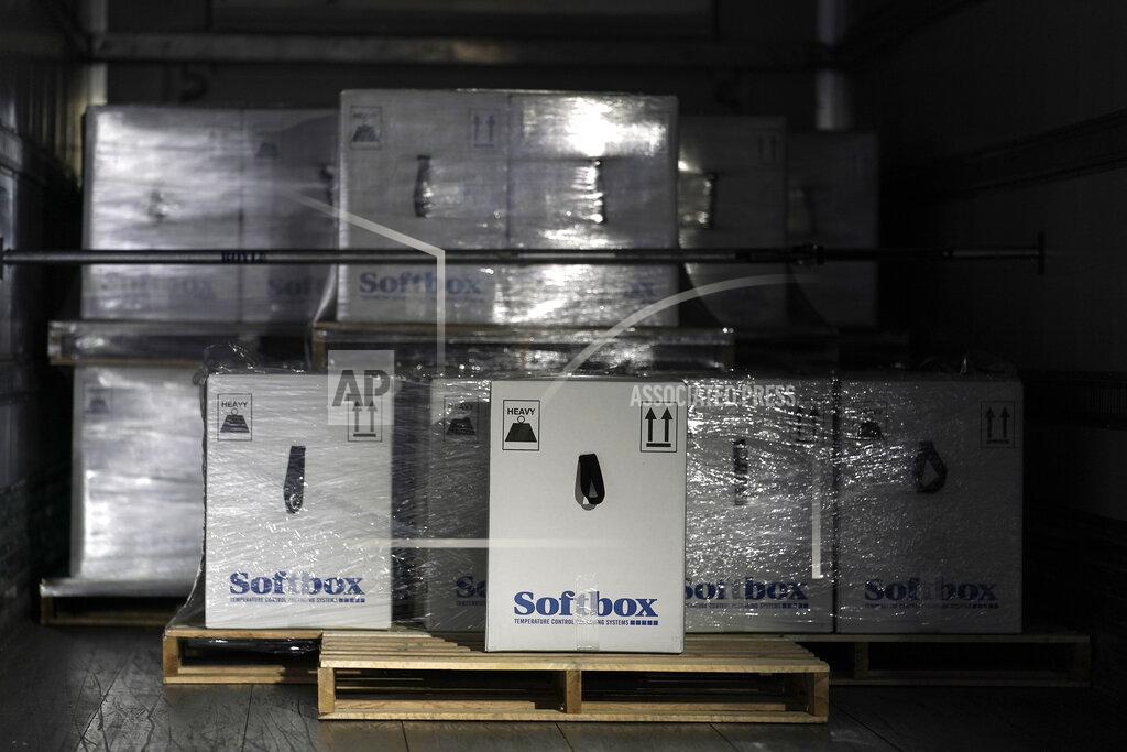 Boxes containing the Pfizer-BioNTech COVID-19 vaccine are prepared to be shipped at the Pfizer Global Supply Kalamazoo manufacturing plant in Portage, Mich., Sunday, Dec. 13, 2020. (AP Photo/Morry Gash, Pool)