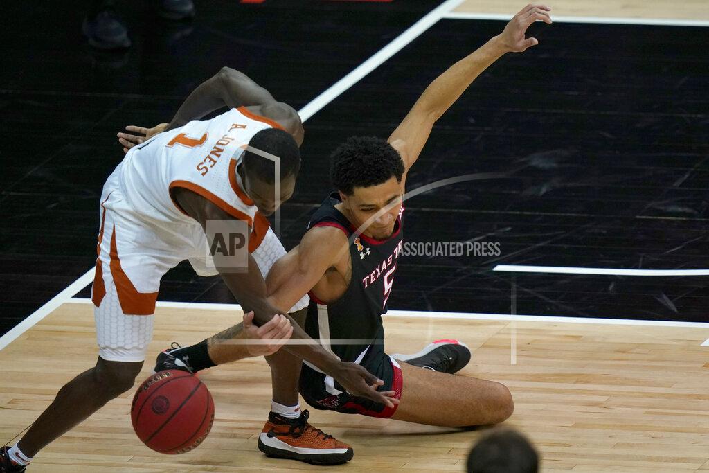 Orlin Wagner Texas guard Andrew Jones (1) and Texas Tech guard Micah Peavy (5) chase a loose ball during the first half of an NCAA college basketball game in the quarterfinal round of the Big 12 men's tournament in Kansas City, Mo., Thursday, March 11, 2021. (AP Photo/Orlin Wagner)