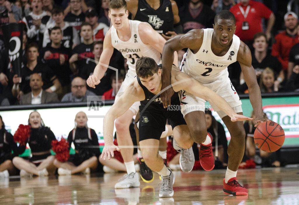 Albert Cesare Cincinnati guard Keith Williams (2) drives past Central Florida guard Matt Milon (2) during the second half of an NCAA college basketball game Wednesday, Feb. 19, 2020, in Cincinnati. (Albert Cesare/The Cincinnati Enquirer via AP)