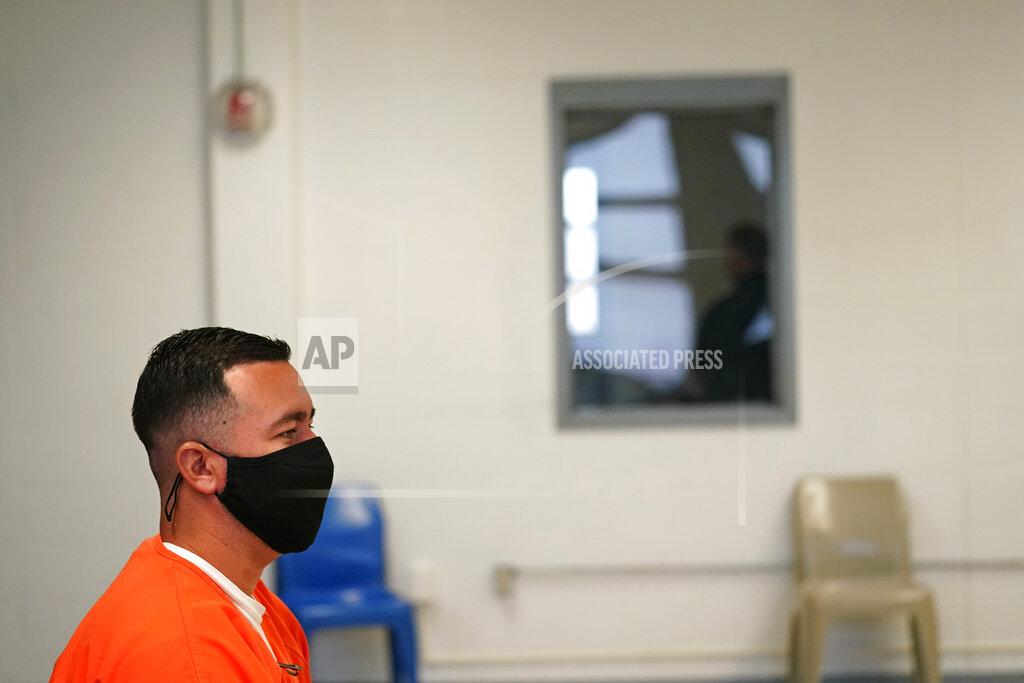 Gerald Herbert Immigration detainee Alexander Martinez speaks during an interview with The Associated Press, while ICE and facility personnel wait outside in the hallway, at the Winn Correctional Center in Winnfield, La., Friday, July 30, 2021. The number of people in federal immigration detention has risen markedly under President Joe Biden. (AP Photo/Gerald Herbert)