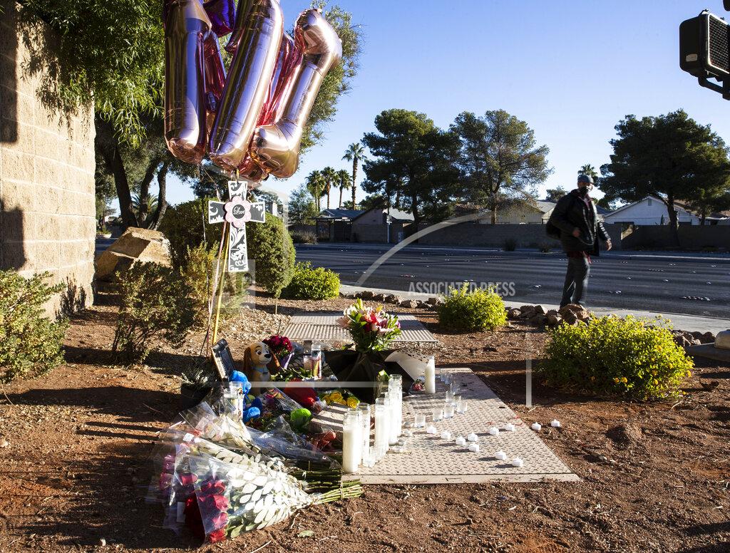 Bizuayehu Tesfaye A pedestrian walks past a makeshift memorial to honor Tina Tintor, 23, at South Rainbow Boulevard and Spring Valley Parkway, on Thursday, Nov. 4, 2021, in Las Vegas. Tintor and her dog were killed when former Raiders wide receiver Henry Ruggs, accused of DUI, slammed into the rear of Tintor's vehicle. (Bizuayehu Tesfaye/Las Vegas Review-Journal)
