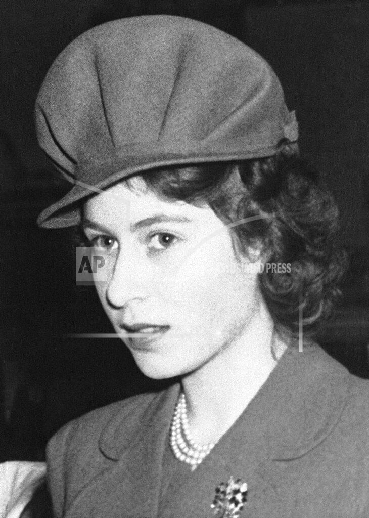 Uncredited FILE - Princess Elizabeth wears a new style of hat during a visit to the Yugo-Slav exhibition at Burlington House on Jan. 31, 1944 in London. Her new choice of hat has distinct military lines -- a small peak and high pleated crown. (AP Photo, File)