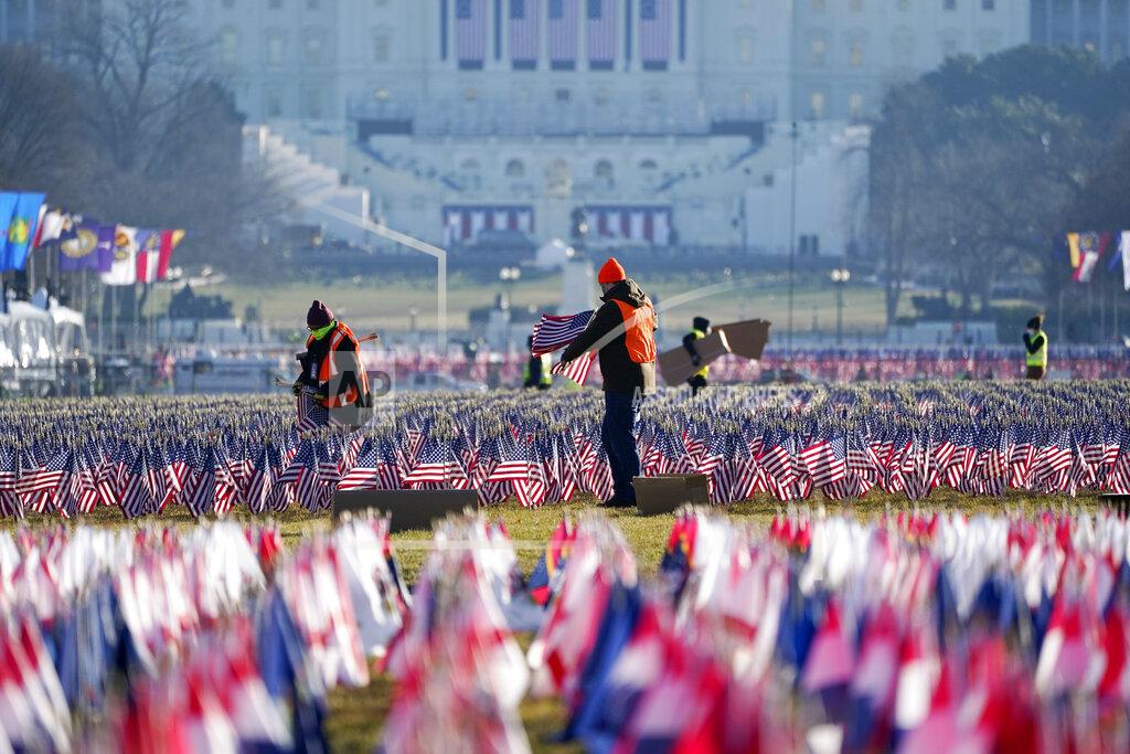 Julio Cortez Workers begin to remove a display of flags on the National Mall one day after the inauguration of President Joe Biden, Thursday, Jan. 21, 2021, in Washington. (AP Photo/Julio Cortez)