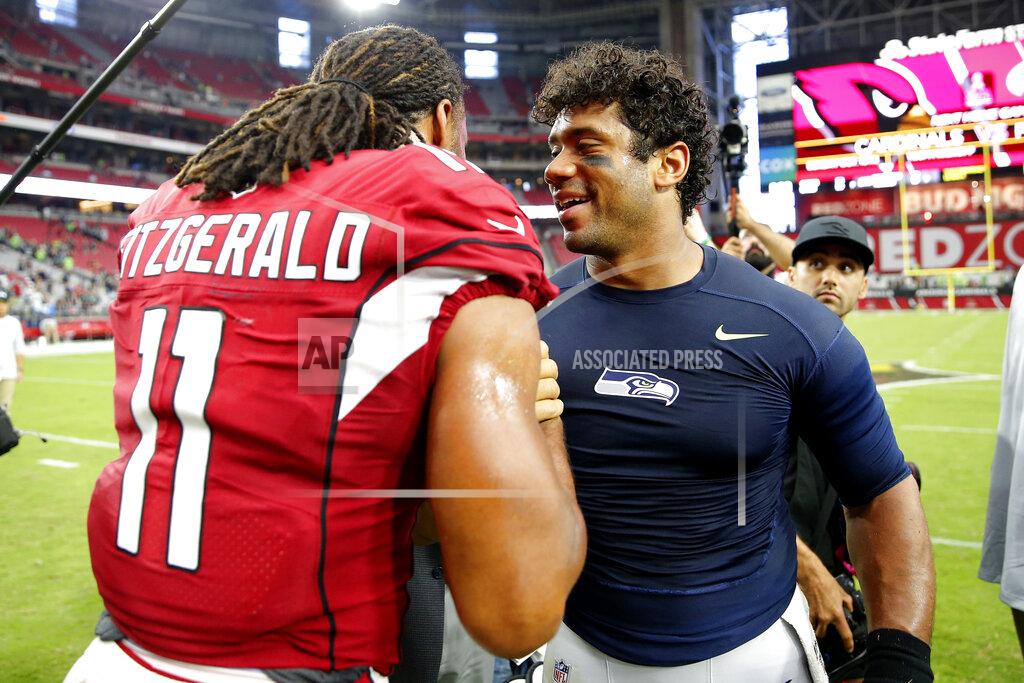 Rick Scuteri Arizona Cardinals wide receiver Larry Fitzgerald (11) greets Seattle Seahawks quarterback Russell Wilson after an NFL football game, Sunday, Sept. 29, 2019, in Glendale, Ariz. The Seahawks won 27-10. (AP Photo/Rick Scuteri)