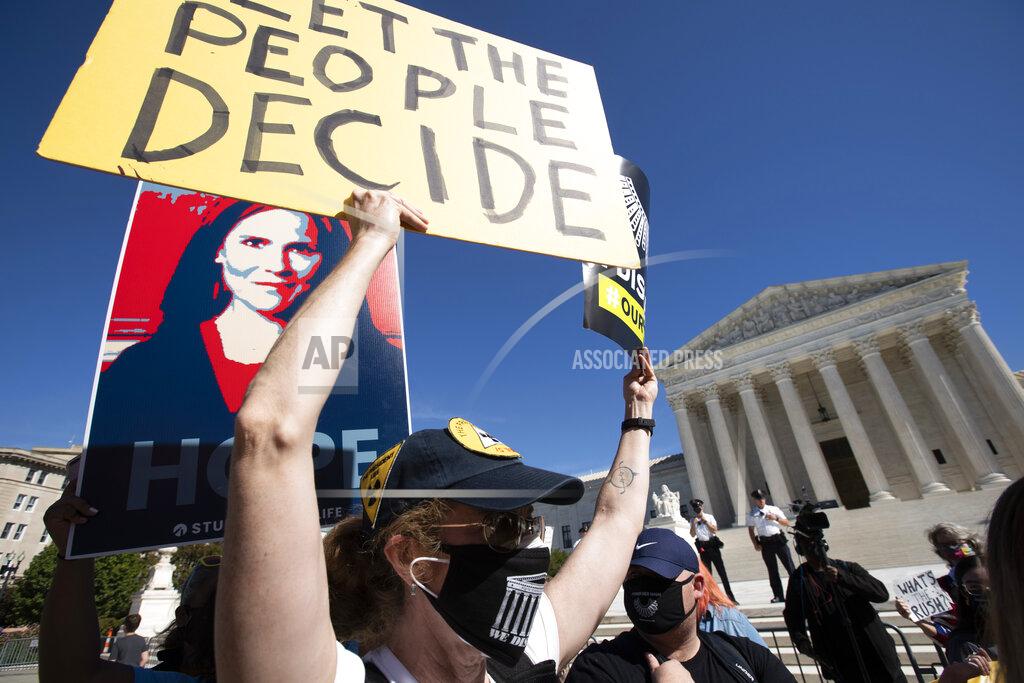 Jose Luis Magana People protest for and against the confirmation of President Donald Trump's Supreme Court nominee Amy Coney Barrett, rally at the Supreme Court on Capitol Hill, in Washington, Wednesday, Oct. 14, 2020. (AP Photo/Jose Luis Magana)
