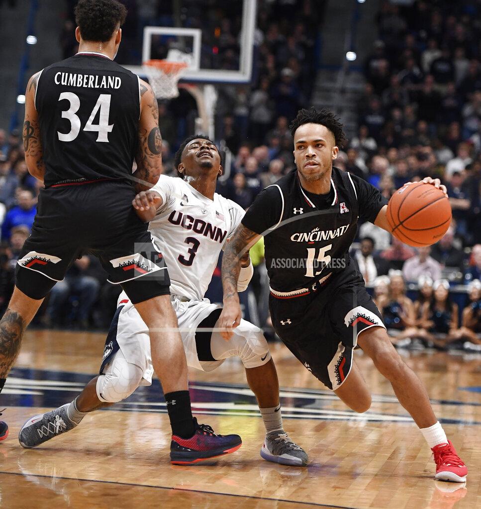 Jessica Hill Connecticut's Alterique Gilbert (3) is stopped by the defense of Cincinnati's Jarron Cumberland (34) as Cincinnati's Cane Broome (15) dribbles around him toward the basket during the second half of an NCAA college basketball game, Sunday, Feb. 24, 2019, in Hartford, Conn. (AP Photo/Jessica Hill)