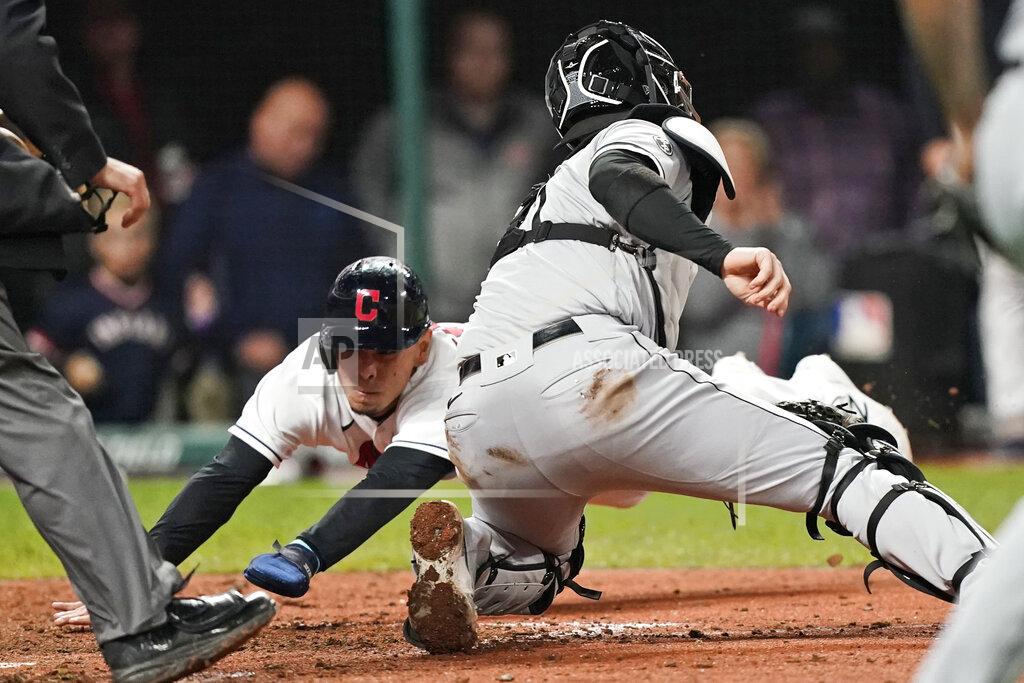 Tony Dejak Cleveland Indians' Andres Gimenez, left, scores ahead of the tag from Chicago White Sox catcher Zack Collins in the sixth inning in the second baseball game of a doubleheader, Thursday, Sept. 23, 2021, in Cleveland. The Indians won 5-3. (AP Photo/Tony Dejak)