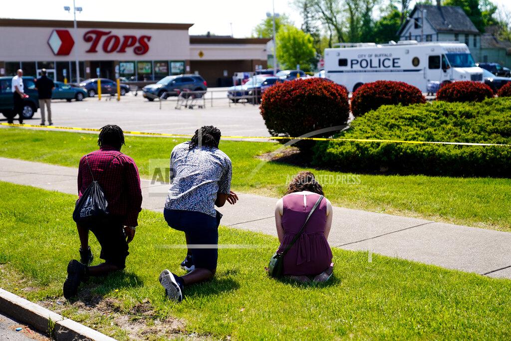 Matt Rourke FILE - People pray outside the scene of a shooting where police are responding at a supermarket, in Buffalo, N.Y., May 15, 2022. When police confronted Payton Gendron, the white man suspected of killing 10 Black people at the supermarket, he had an AR-15-style rifle and was cloaked in body armor. Yet officers talked to Gendron, convinced him to put down his weapon and arrested him without firing a single shot. Some people are asking why that type of treatment hasn't been afforded to Black people in encounters where they were killed over minor traffic infractions, or no infractions at all. (AP Photo/Matt Rourke, File)