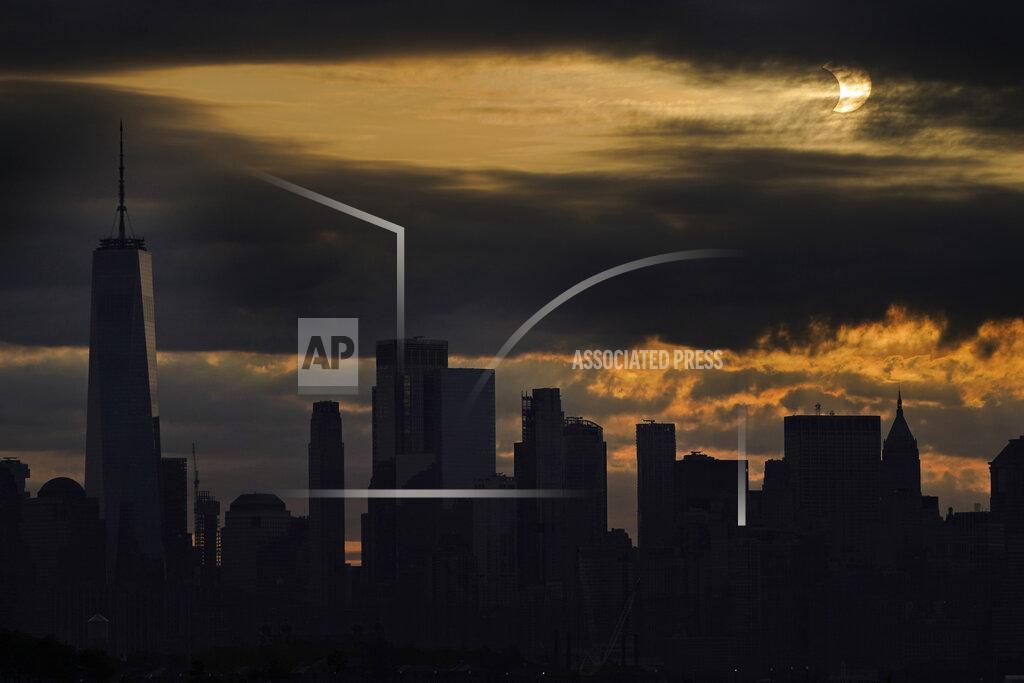 Seth Wenig The sun is partially eclipsed as it rises over lower Manhattan in New York, Thursday, June 10, 2021. (AP Photo/Seth Wenig)