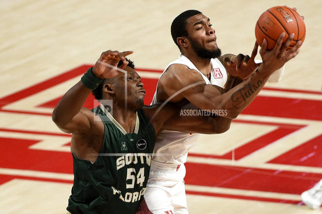 Eric Christian Smith Houston forward Reggie Chaney, right, and South Florida center Russel Tchewa vie for a rebound during the second half of an NCAA college basketball game, Sunday, Feb. 28, 2021, in Houston. (AP Photo/Eric Christian Smith)