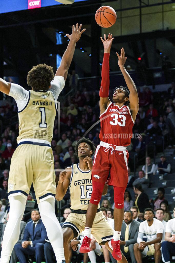 Danny Karnik Arkansas guard Jimmy Whitt Jr. (33) shoots over Georgia Tech forward James Banks III (1) in the first half of an NCAA college basketball game Monday, Nov. 25, 2019, in Atlanta. (AP Photo/Danny Karnik)