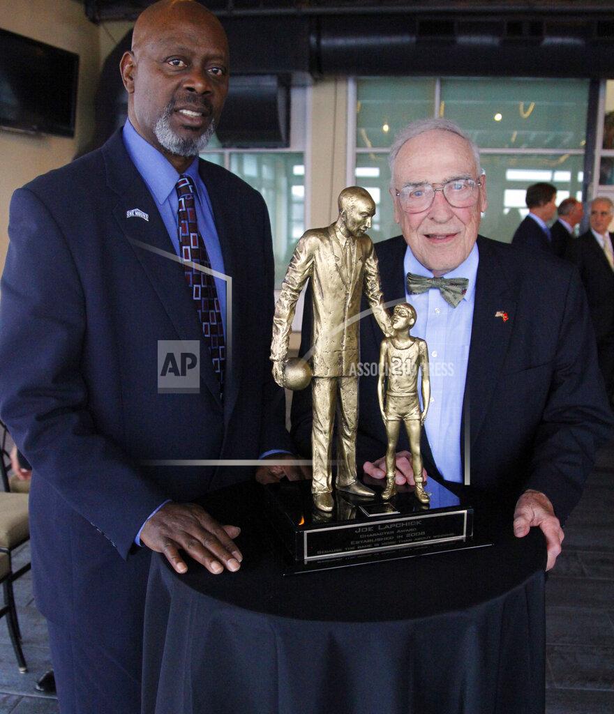 Bebeto Matthews FILE - Fred Carter, left, poses for a photo with his former Mount St. Mary's NCAA college basketball head coach Jim Phelan, and the Lapchick Character Award statue at a presentation luncheon in New York, in this Thursday, Nov. 17, 2011, file photo. Carter introduced Phelan for the award recognizing basketball coaches of "both exemplary character and coaching ability." Phelan, the bow-tied basketball coach who won 830 games during nearly a half-century at Mount St. Mary's, has died. He was 92. The athletic department at Mount St. Mary's said Phelan died in his sleep at home Tuesday night. (AP Photo/Bebeto Matthews)