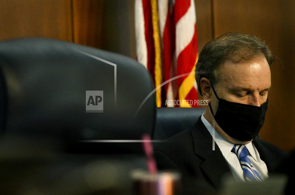 Laurie Skrivan St. Louis County Executive Sam Page listens to the St. Louis County Council members cast their votes to repeal the mask mandate during a St. Louis County Council meeting on Tuesday, July 27, 2021, in Clayton, Mo. (Laurie Skrivan/St. Louis Post-Dispatch via AP)