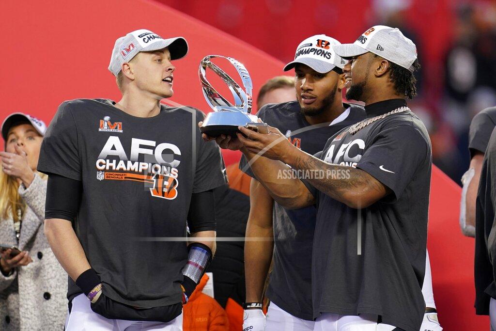 Paul Sancya Cincinnati Bengals quarterback Joe Burrow, left, celebrates with teammates as they hold the Lamar Hunt trophy after the AFC championship NFL football game against the Kansas City Chiefs, Sunday, Jan. 30, 2022, in Kansas City, Mo. The Bengals won 27-24 in overtime. (AP Photo/Paul Sancya)