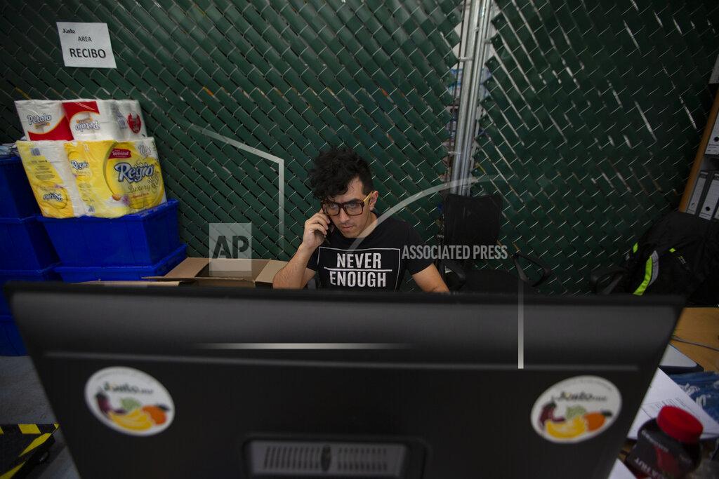 Fernando Llano A worker answers customer calls in the service area of Justo, an online supermarket in Mexico City, Friday, April 24, 2020. Justo was founded just one year ago as Mexico's first online only grocer, and in the wake of the new coronavirus pandemic, sales have soared to record levels. (AP Photo/Fernando Llano)