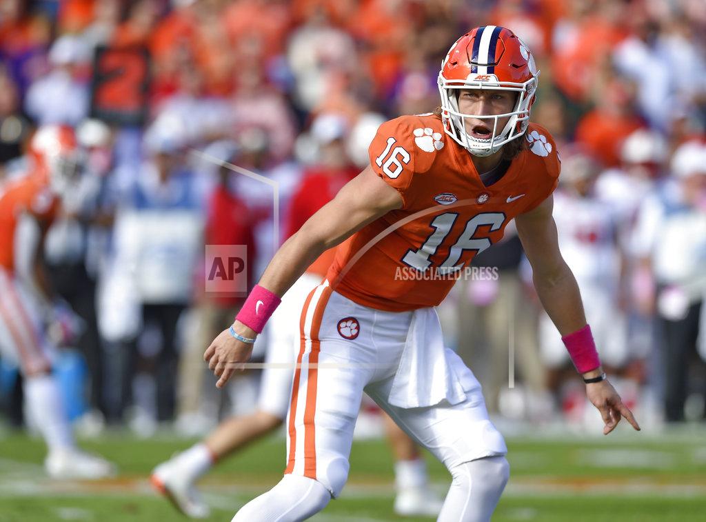 Richard Shiro FILE - In this Oct. 20, 2018, file photo, Clemson quarterback Trevor Lawrence calls a play during the first half of the team's NCAA college football game against North Carolina State in Clemson, S.C. Clemson and Notre Dame weren’t even a month into this season when both made unexpected quarterback switches. The Tigers and Fighting Irish were undefeated with senior quarterbacks who had won a lot of games, and neither of those starters was even injured. Still, the coaches for both teams decided to make a change then--and are still without a loss going for a national title. After playing behind Kelly Bryant in each of Clemson’s first four games, Lawrence was named the starter before the Sept. 29 game at Wake Forest. (AP Photo/Richard Shiro, File)