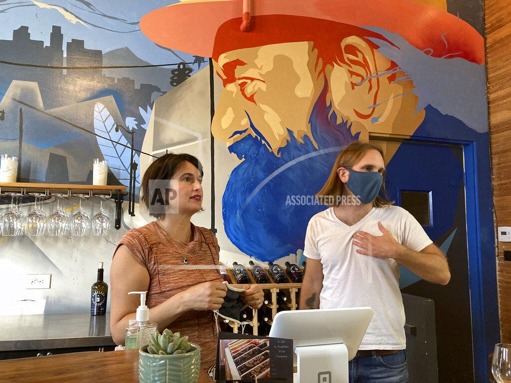 Uncredited In this Sunday, May 2, 2021, photo, Angeleno Wine Company owners Amy Luftig Viste, left, and Jasper Dickson pose for a picture in downtown Los Angeles. When Angeleno Wine Co. reopened its tasting room to the public, Luftig Viste teared up seeing old friends reunited for the first time since the pandemic had shuttered so many businesses that it left major cities looking like ghost towns. "It felt like the winery had come alive again," Luftig Viste said Sunday, the day after it officially reopened after being closed all but two weeks over the past 13 months. (AP Photo/Brian Melley)