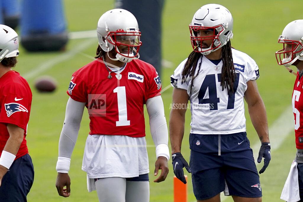 Mary Schwalm New England Patriots quarterback Cam Newton (1) talks with Jakob Johnson (47) during NFL football practice in Foxborough, Mass., Friday, June 4, 2021. (AP Photo/Mary Schwalm)
