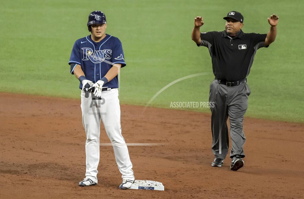 Steve Nesius Umpire Adrian Johnson gestures for time out after Tampa Bay Rays' Yoshi Tsutsugo reaches send base with a double off Oakland Athletics' Frankie Montas during the second inning of a baseball game Tuesday, April 27, 2021, in St. Petersburg, Fla. (AP Photo/Steve Nesius)