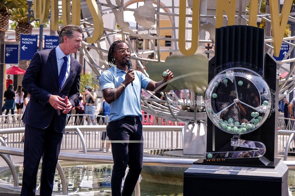 Ringo H.w. Chiu California Governor Gavin Newsom, left, looks on as Access Hollywood personality Scott Evans draws a ball with a winning number during the Vax for the Win lottery contest at Universal Studios in Universal City, Calif., Tuesday, June 15, 2021. Starting Tuesday, there were no more state rules on social distancing, and no more limits on capacity at restaurants, bars, supermarkets, gyms, stadiums or anywhere else. (AP Photo/Ringo H.W. Chiu)