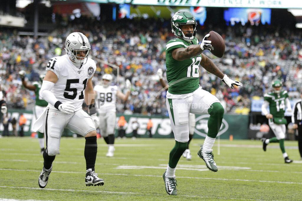 Adam Hunger ADDS THAT THE TOUCHDOWN WAS LATER NULLIFIED BY PENALTY - New York Jets wide receiver Demaryius Thomas (18) runs away from Oakland Raiders inside linebacker Will Compton (51) for a touchdown during the first half of an NFL football game Sunday, Nov. 24, 2019, in East Rutherford, N.J. The touchdown was later nullified by penalty. (AP Photo/Adam Hunger)