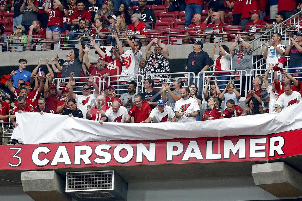 Rick Scuteri Fans unveil former Arizona Cardinals quarterback Carson Palmer's name in the Cardinals' ring of honor at half time an NFL football game against the Seattle Seahawks, Sunday, Sept. 29, 2019, in Glendale, Ariz. (AP Photo/Rick Scuteri)