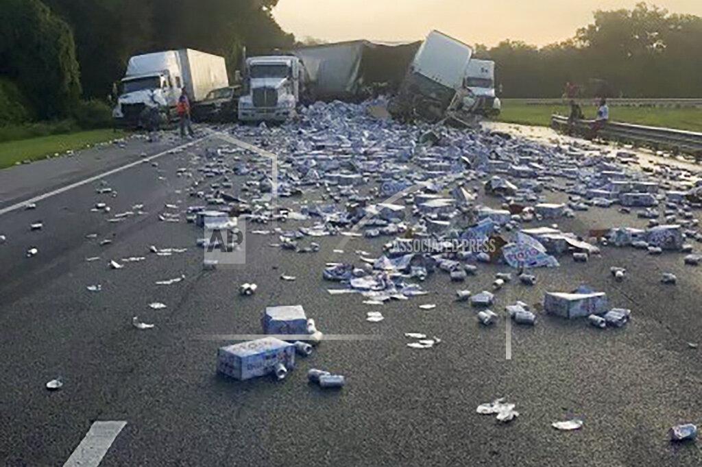 Uncredited In this photo provided by Florida Highway Patrol, cases of Coors Light beer are strewn across a highway after two semitrailers collided on a Florida highway on Wednesday, Sept. 21, 2022, near Brooksville, Fla. (Florida Highway Patrol via AP)