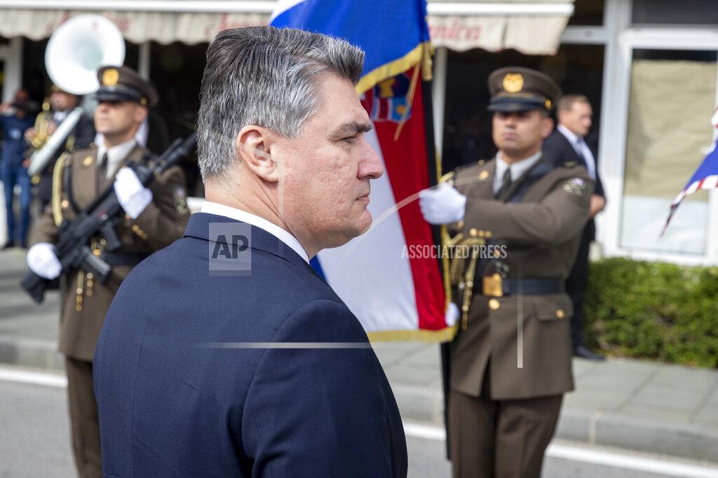 Darko Bandic Croatia's President Zoran Milanovic reviews the honor guards as he arrives at a ceremony in Knin, Croatia, Wednesday, Aug. 5, 2020. Croatia marked the 25th anniversary of a victorious wartime military offensive, with an ethnic Serb politician attending the ceremony for the first time in what is seen as an important step toward reconciliation. (AP Photo/Darko Bandic)