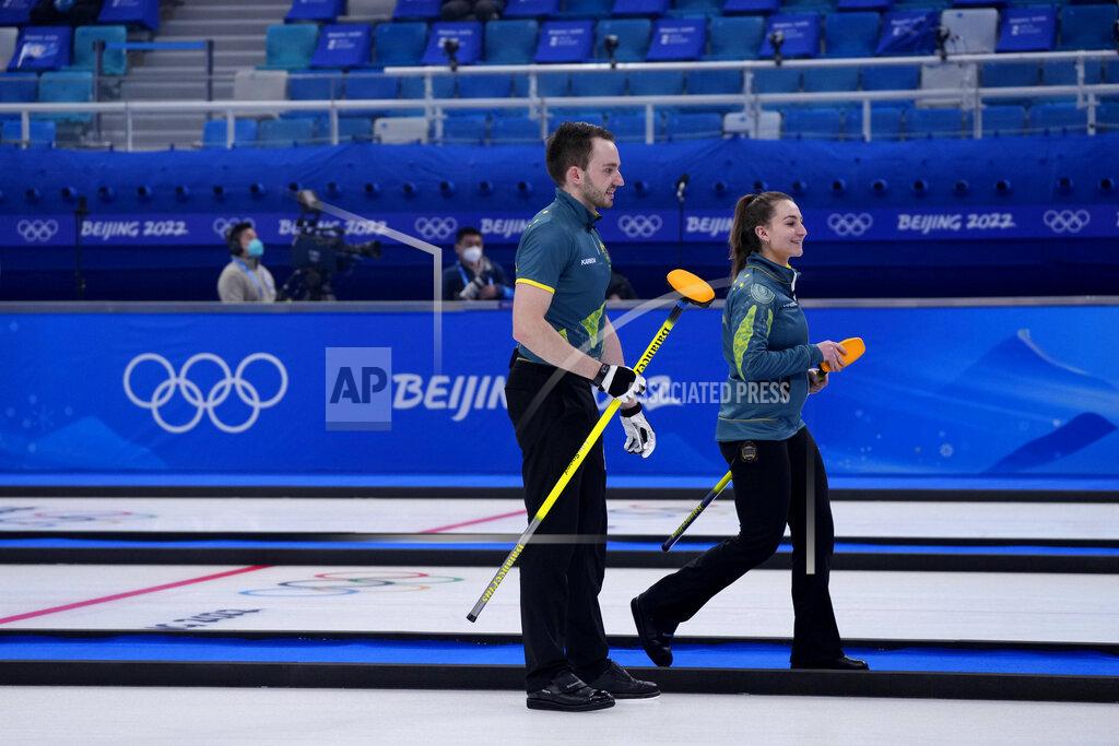 Australia's Tahli Gill and Dean Hewitt, compete during the mixed doubles curling match against Switzerland, at the 2022 Winter Olympics, Sunday, Feb. 6, 2022, in Beijing. (AP Photo/Nariman El-Mofty)