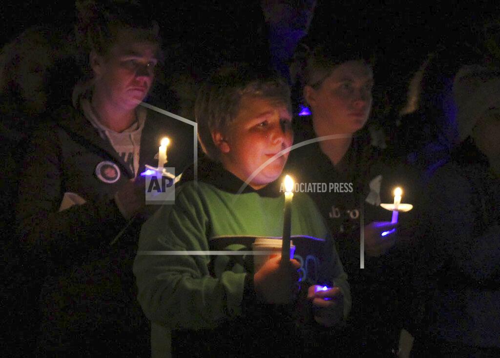 Dean Shalhoup People attend a candlelight vigil in remembrance of 5-year-old Elijah Lewis at Watson Park in Merrimack, N.H, Sunday, Oct. 24, 2021. Hundreds of people gathered for the candlelight vigil for the young boy from New Hampshire who went missing a month ago and was recently found dead. (Dean Shalhoup/The Telegraph via AP)