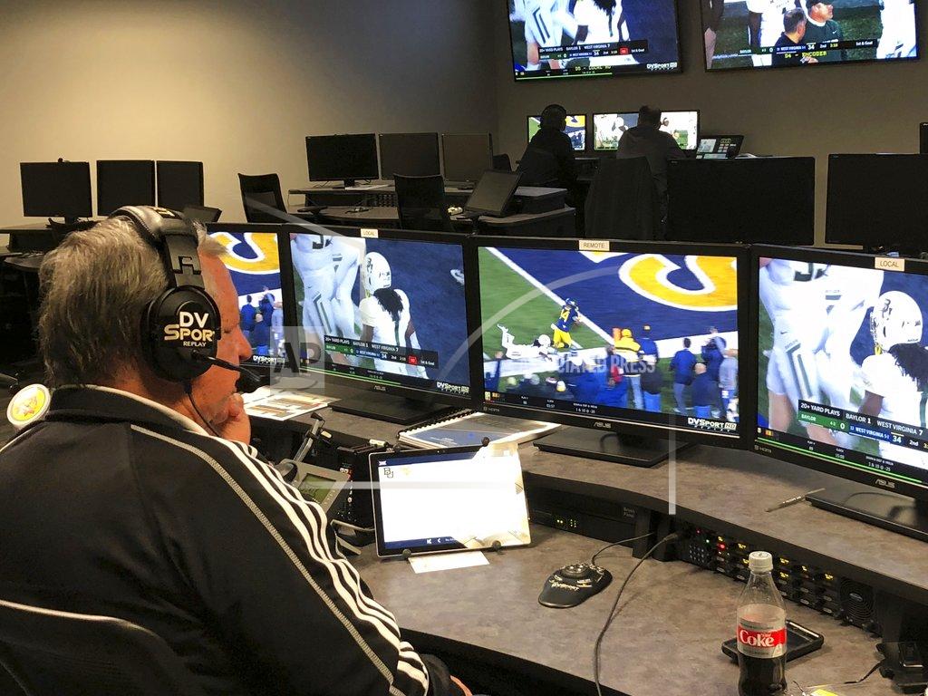 Stephen Hawkins David Warden, the Big 12's replay coordinator, reviews a play from the West Virginia-Baylor NCAA college football game in the conference's centralized replay center in Irving, Texas, Thursday, Oct. 25, 2018. In the background at rear left, at one of the centers six game stations, is the two-man crew assigned specifically to cover the Baylor-West Virginia NCAA college football game. (AP Photo/Stephen Hawkins)