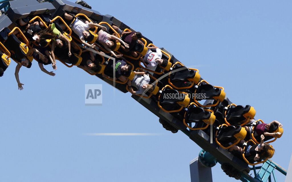 Alessandra Tarantino Visitors enjoy a ride a roller coaster at Cinecitta' World amusement park in the outskirts of Rome in the day of its reopening, Thursday, June 17, 2021. Amusement parks have been closed since Oct. 25 2020, when Italy's second national lockdown started. (AP Photo/Alessandra Tarantino)