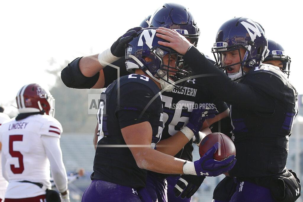 Jim Young Northwestern's Tyler Haskin, second left, celebrates his touchdown with Aidan Smith, right, as Massachusetts's Donte Lindsey, left, walks off the field during the first half of an NCAA college football game Saturday, Nov. 16, 2019, in Evanston, Ill. (AP Photo/Jim Young)