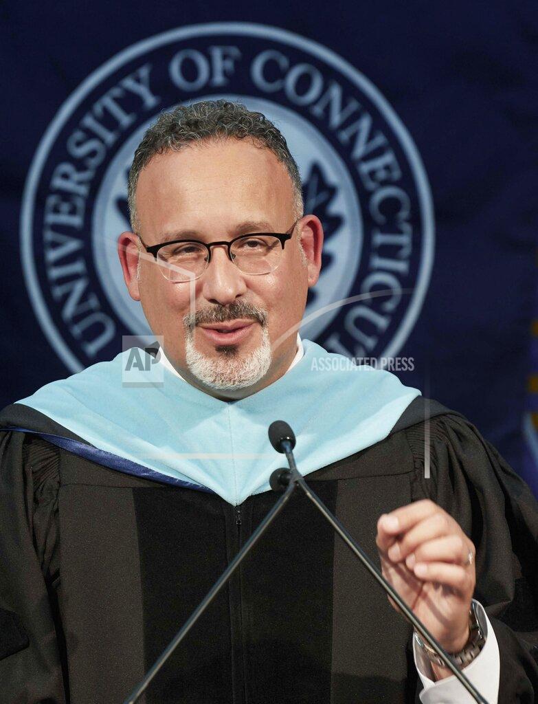Peter Morenus This photo shows U.S. Secretary of Education Miguel Cardona as he delivers remarks, during a video recording address for University of Connecticut graduating students at Pratt & Whitney Stadium in East Hartford, Conn., Friday May 7, 2021. (Peter Morenus/UConn Photo via AP)