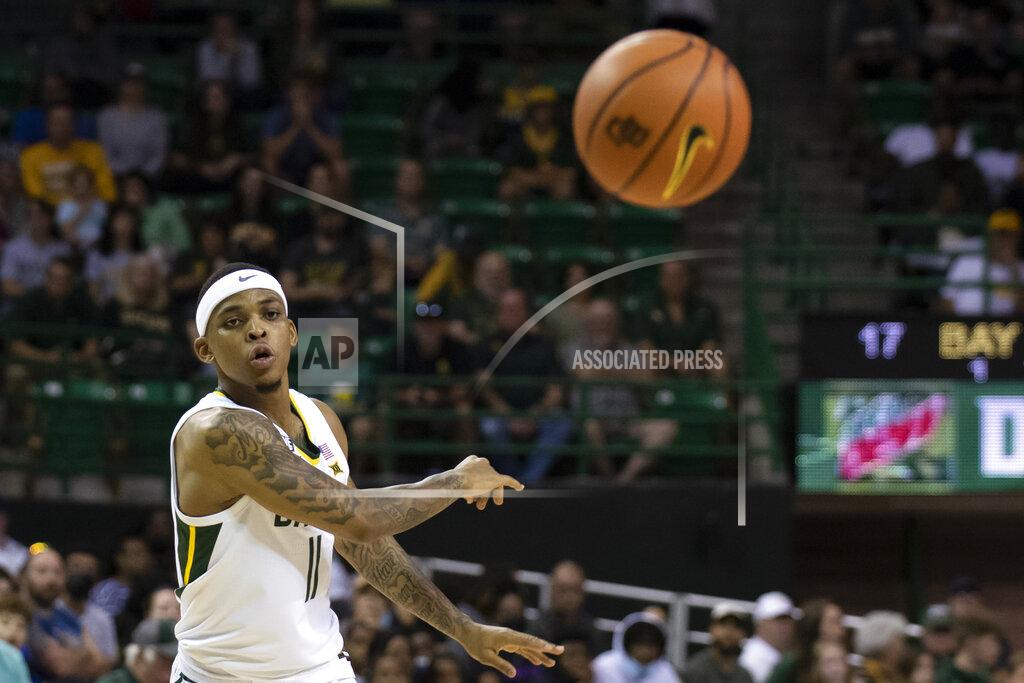 Emil Lippe Baylor guard James Akinjo (11) passes the ball to a teammate in the first half of an NCAA college basketball game against Arkansas Pine Bluff in Waco, Texas, Saturday, Dec. 4, 2021. (AP Photo/Emil Lippe)