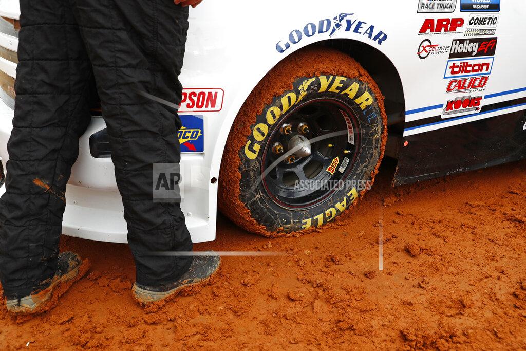 Wade Payne Mud stick to the tire of a truck as it prepares to compete in a heat race for a NASCAR Truck Series race on Saturday, March 27, 2021, in Bristol, Tenn. (AP Photo/Wade Payne)